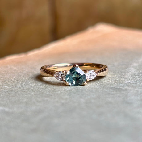 Green sapphire and diamond three-stone engagement ring