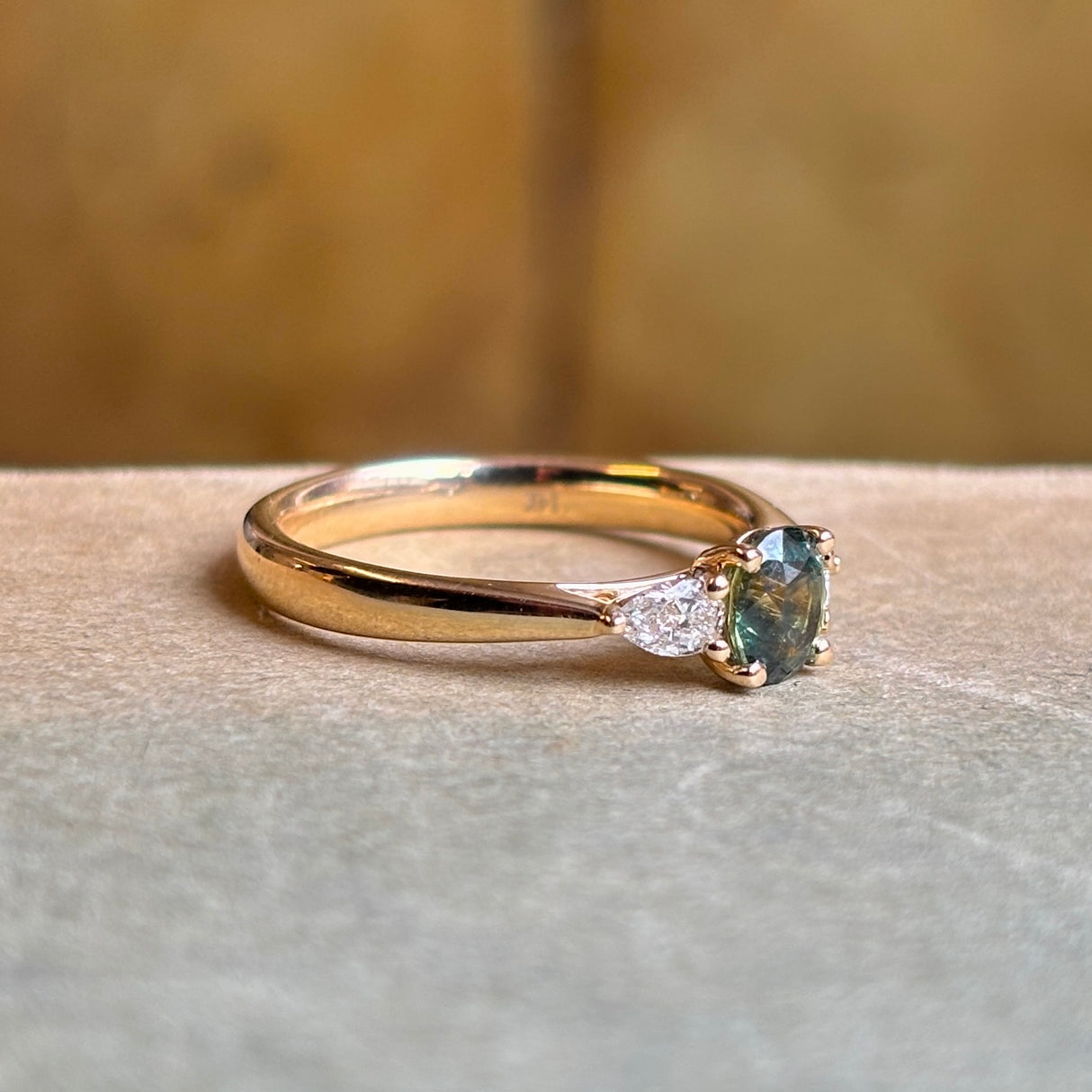 Teal sapphire and diamond three-stone engagement ring
