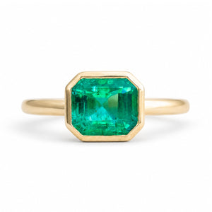 An antique-inspired, Emerald solitaire engagement ring set in 14ct yellow gold.