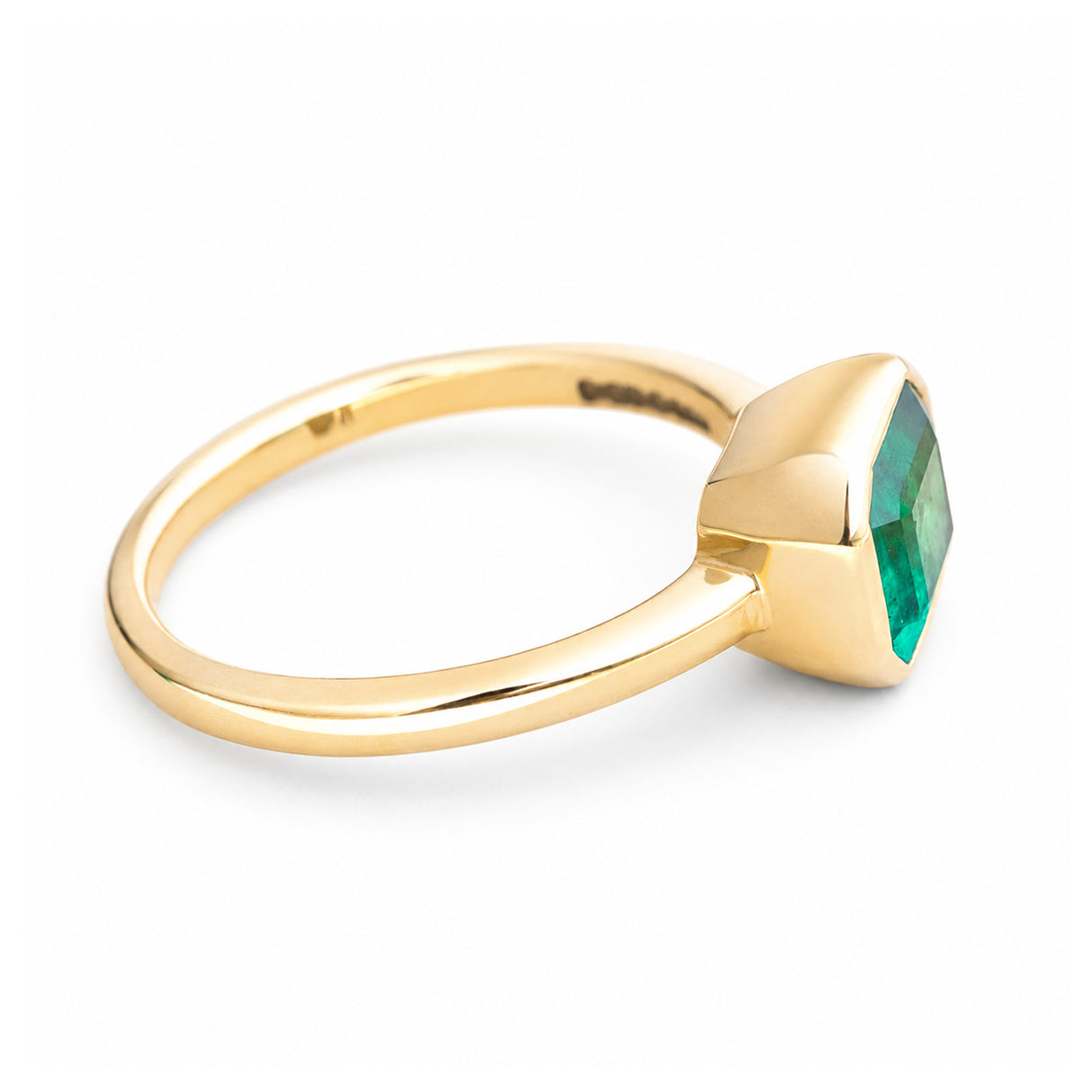 A vintage-inspired yellow gold solitaire engagement ring with an emerald at the centre.