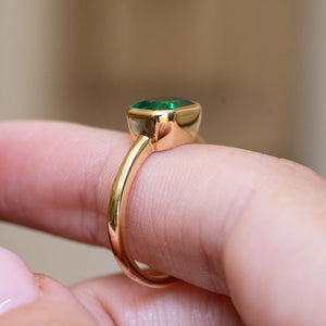 Gallery detail of an antique-inspired emerald-cut emerald solitaire engagement ring in 14ct yellow gold.