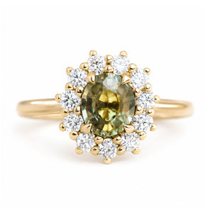 An antique-inspired, Green sapphire and diamond halo cluster engagement ring set in 14ct yellow gold.