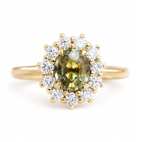 An antique-inspired, Green sapphire and diamond halo cluster engagement ring set in 14ct yellow gold.