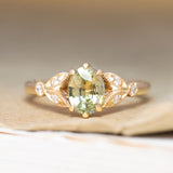 A vintage-inspired, green sapphire & diamond engagement ring in yellow gold.