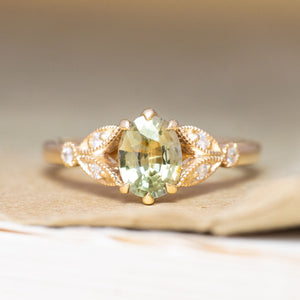 A vintage-inspired, green sapphire & diamond engagement ring in yellow gold.