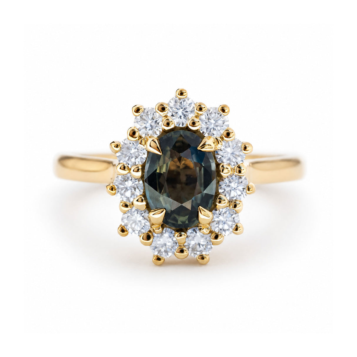 An antique-inspired, green oval sapphire and diamond halo cluster engagement ring in yellow gold. 