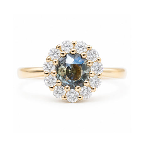 Antique-inspired earthy green sapphire and diamond halo engagement ring in yellow gold.