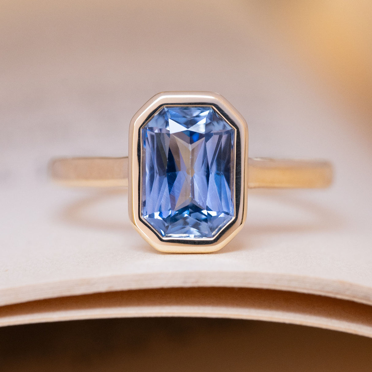 Antique-inspired pale blue sapphire solitaire engagement ring in yellow gold.