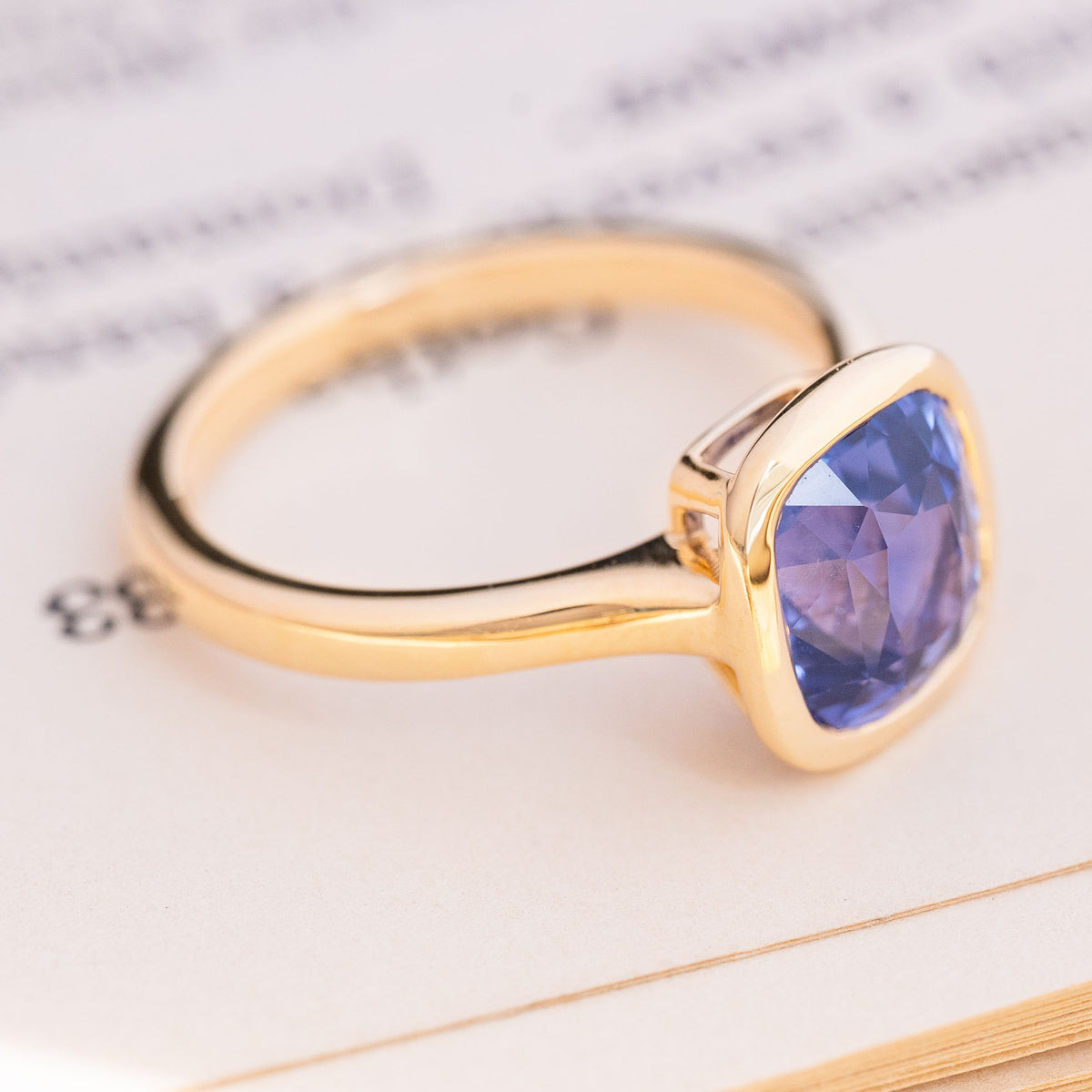 Antique-inspired, vivid violet sapphire solitaire engagement ring