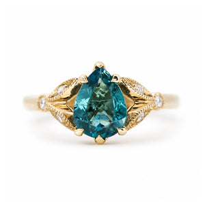 Vintage-inspired teal tourmaline and diamond engagement ring in yellow gold