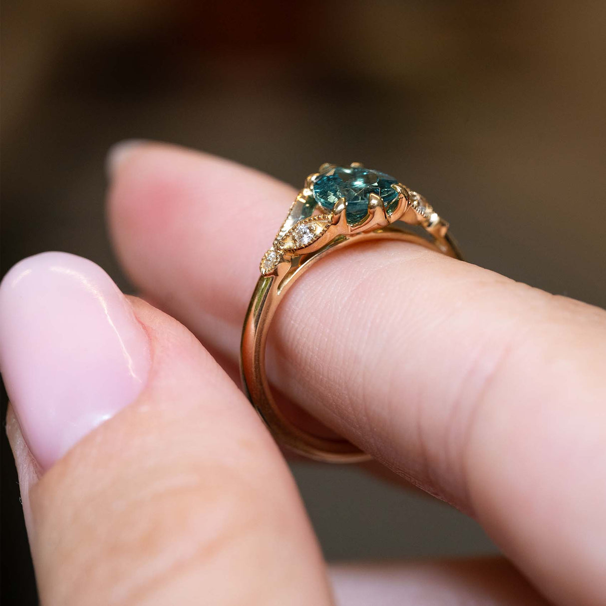 Side profile showing the ornate gallery of a vintage-inspired tourmaline ring