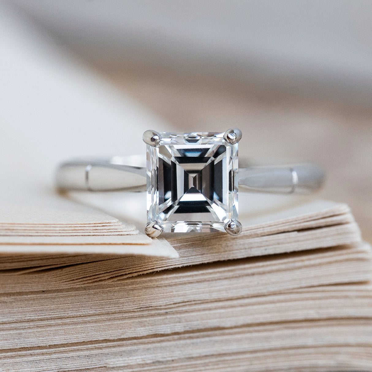 A Vintage 1980s step-cut solitaire diamond engagement ring in platinum.