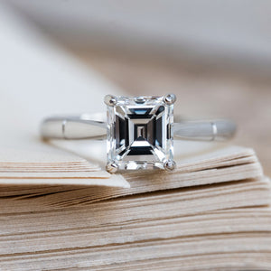 A Vintage 1980s step-cut solitaire diamond engagement ring in platinum.