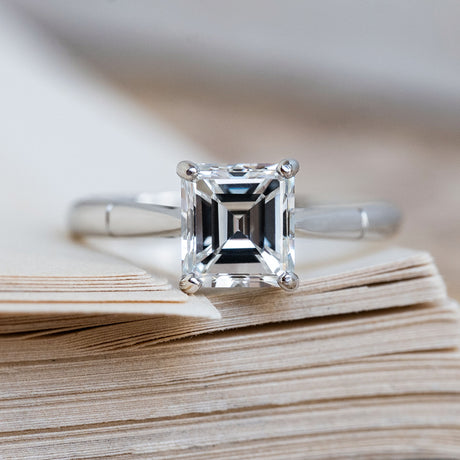 A Vintage 1980s step-cut solitaire diamond engagement ring in platinum.