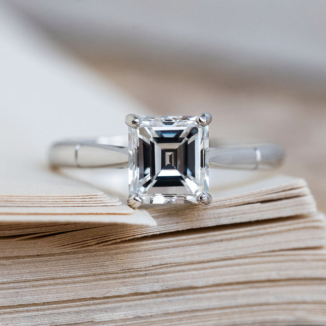 A Vintage 1980s step-cut solitaire diamond engagement ring in platinum.