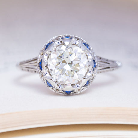 Antique, Art Deco diamond and sapphire cluster ring in white gold and platinum.