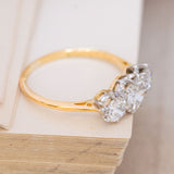 An antique old-cut diamond three-stone ring with 18ct yellow gold and platinum.
