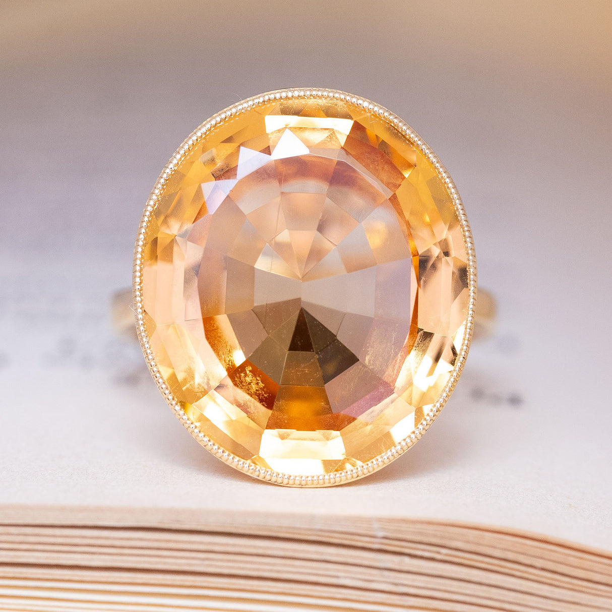 A vintage, 19th century, orange topaz cocktail solitaire ring in yellow gold.