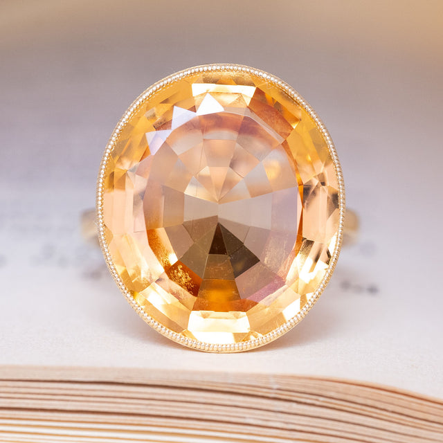 A vintage, 19th century, orange topaz cocktail solitaire ring in yellow gold.