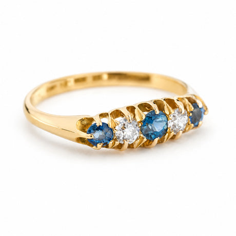 A yellow gold antique ring with a blue sapphire & diamond five-stone ring.