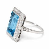 An antique Art Deco aquamarine and diamond cocktail ring in platinum viewed from an angle.