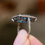 Side detail of an antique Art Deco aquamarine and diamond cocktail ring in platinum showing the pierced gallery.