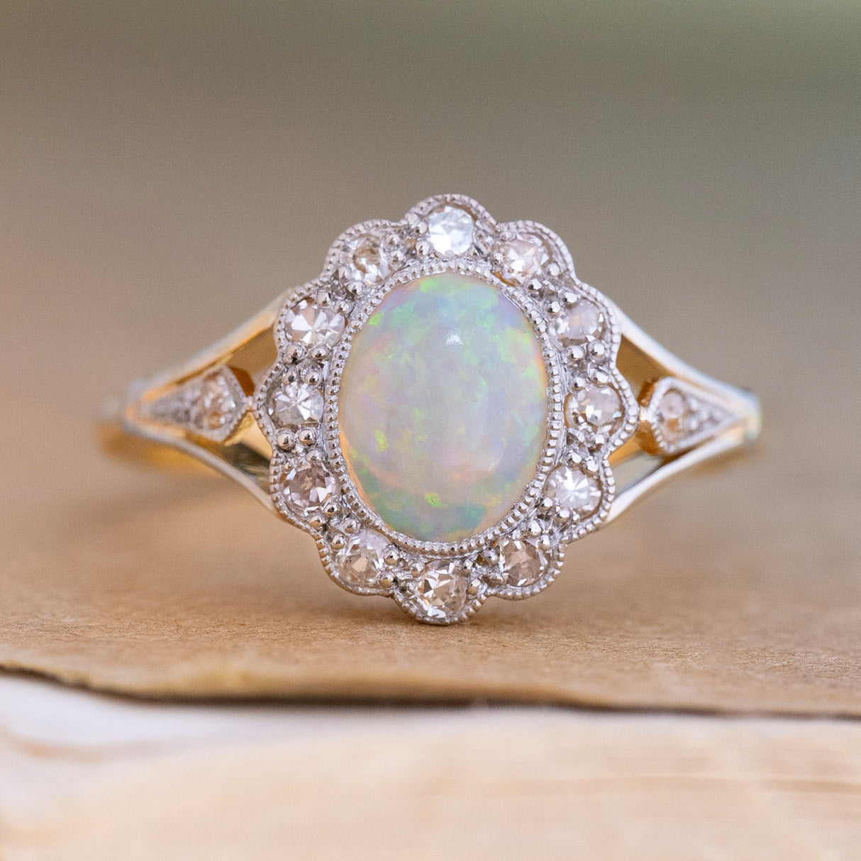 An antique, Edwardian opal & diamond cluster ring in 18ct yellow gold and platinum.
