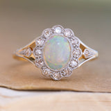 An antique, Edwardian opal & diamond cluster ring in 18ct yellow gold and platinum.
