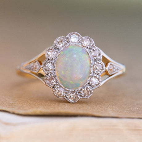 An antique, Edwardian opal & diamond cluster ring in 18ct yellow gold and platinum.