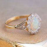 An antique, Edwardian opal & diamond cluster ring in yellow gold and platinum showing the details on the shoulder.