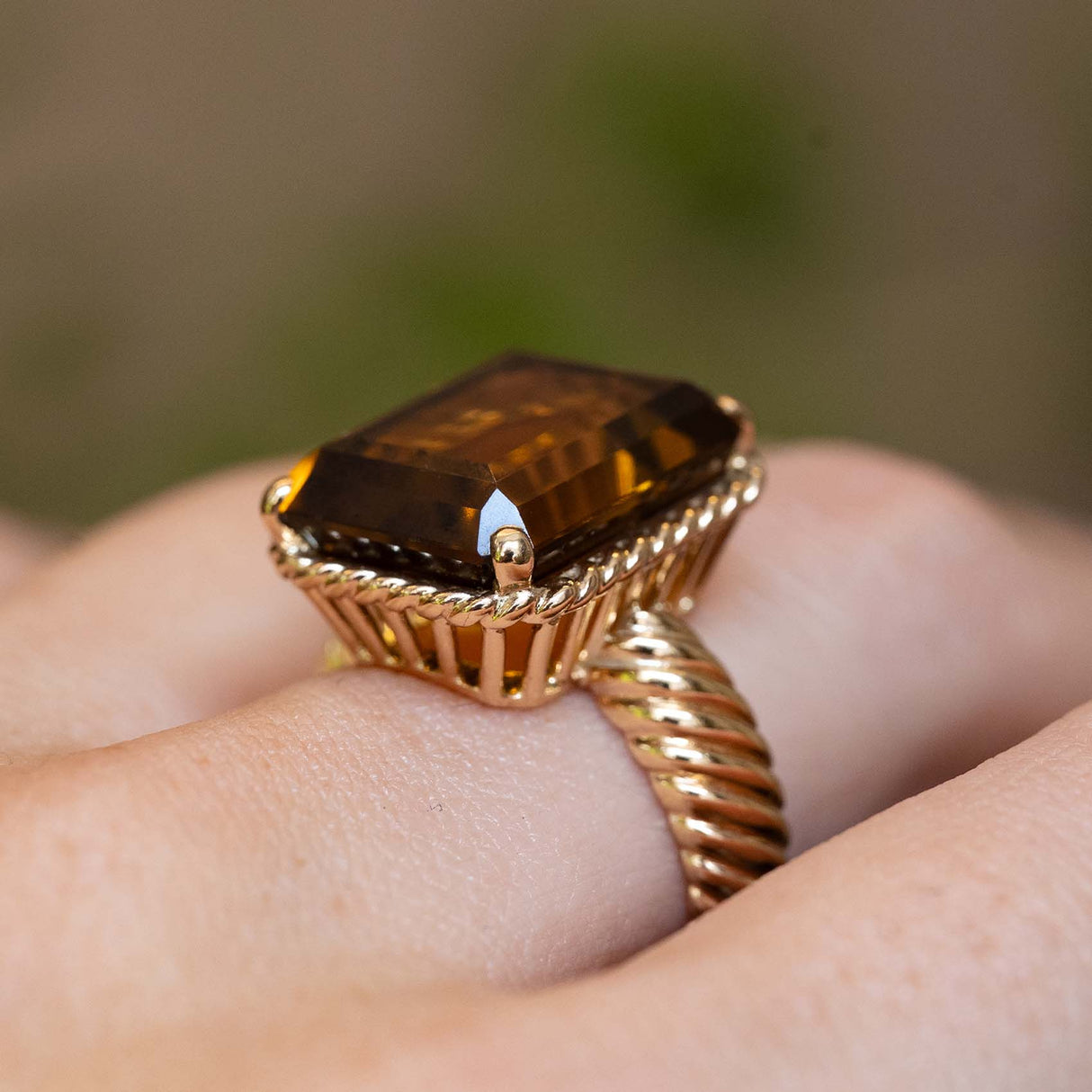 Side view of a vintage 1970s Cartier smoky quartz cocktail ring in yellow gold.