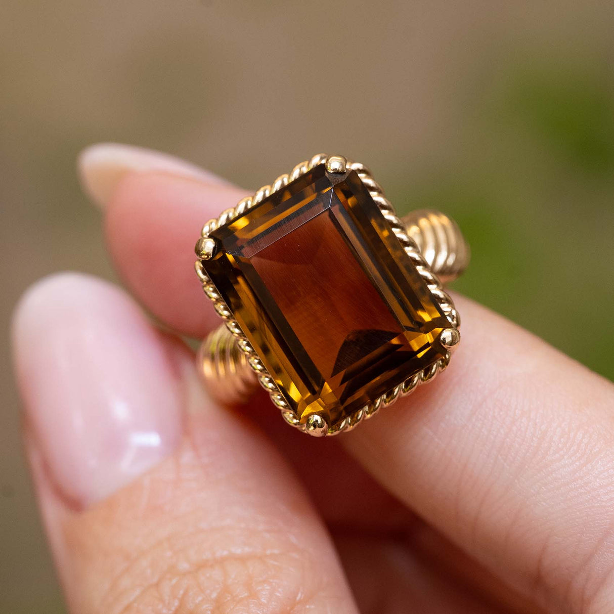 Close detail of a vintage Cartier smoky quartz cocktail ring with an emerald-cut smoky quartz.