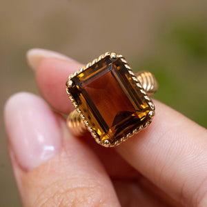 Close detail of a vintage Cartier smoky quartz cocktail ring with an emerald-cut smoky quartz.