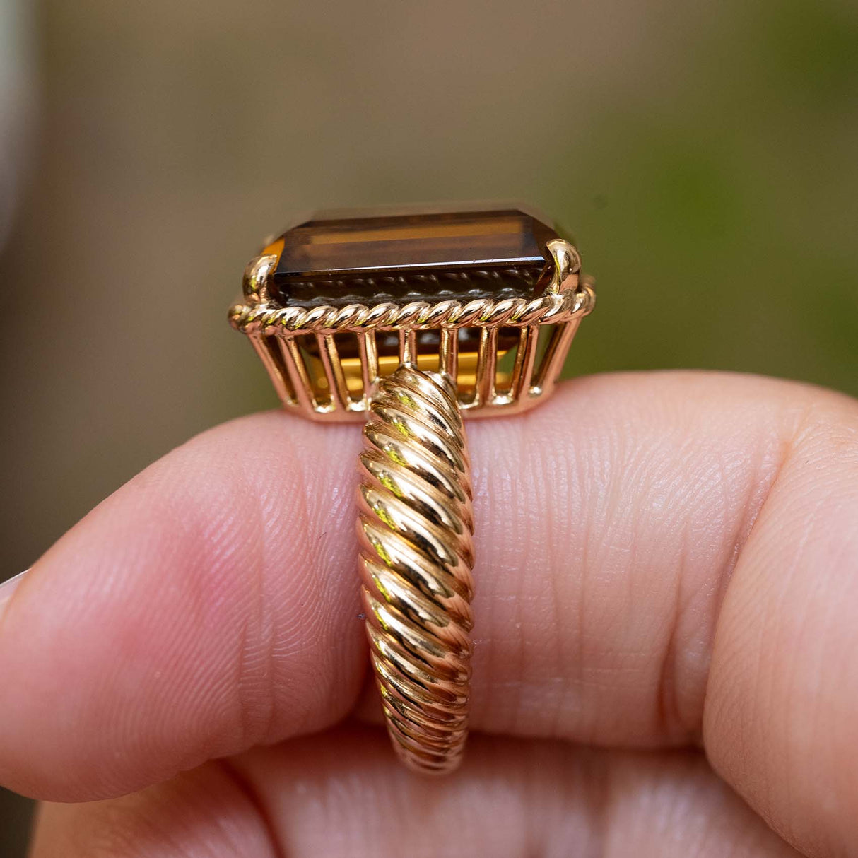 Gallery view of a vintage 1970s Cartier smoky quartz cocktail ring with a twisted yellow gold band.