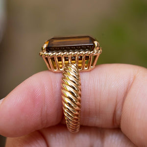 Gallery view of a vintage 1970s Cartier smoky quartz cocktail ring with a twisted yellow gold band.