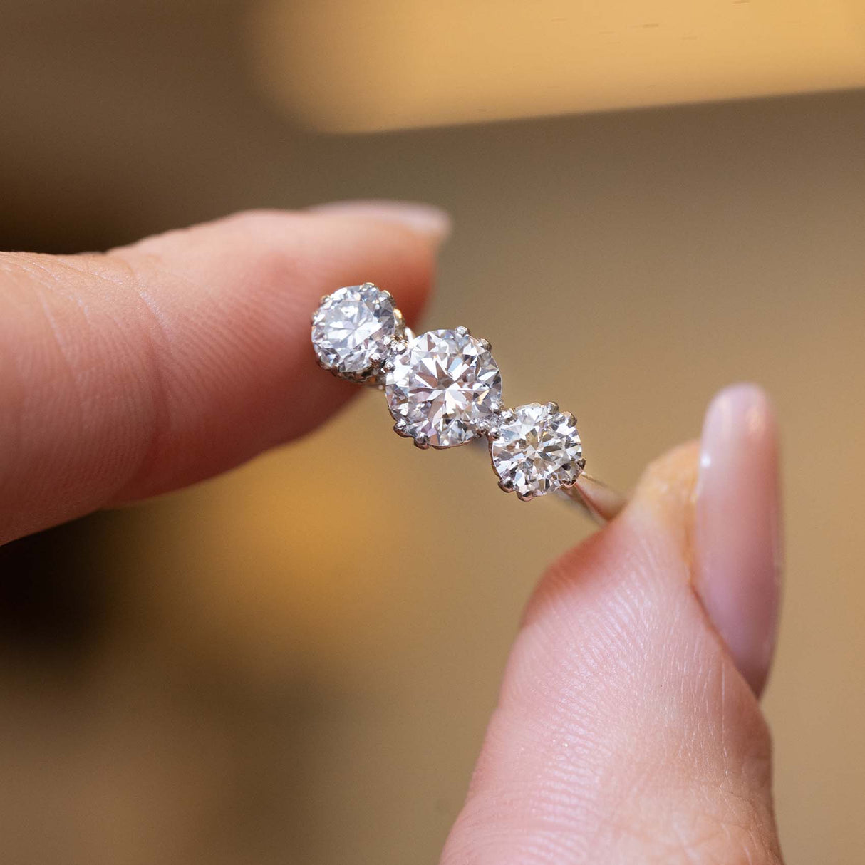Close-up of three round diamonds in an antique Edwardian engagement ring