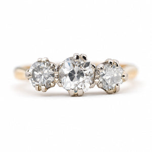 Vintage 1960s old-cut diamond three-stone engagement ring in yellow gold.