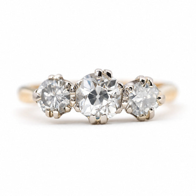 Vintage 1960s old-cut diamond three-stone engagement ring in yellow gold.