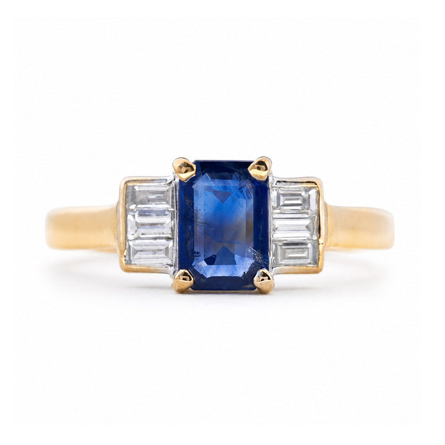 A vintage 1960s sapphire and diamond three-stone engagement ring in yellow gold.