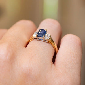 Angled view of the vintage sapphire ring worn on the hand