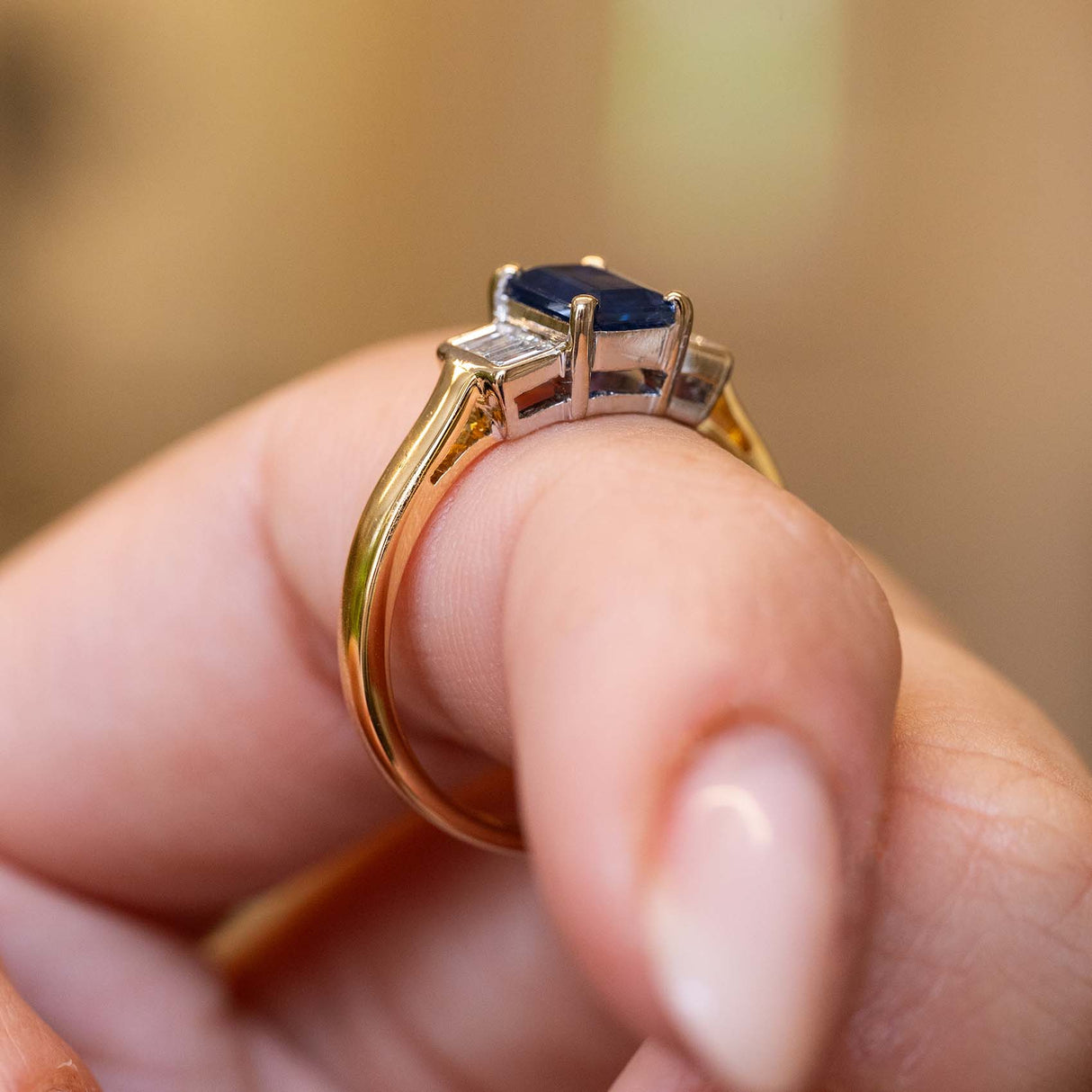 A Side profile of a 1960s sapphire engagement ring showing the raised gallery.