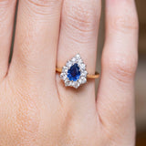 Close-up of a 1980s sapphire and diamond engagement ring on the finger