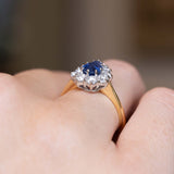 Angled side view of the sapphire cluster ring with a yellow gold band