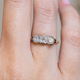 Close-up of an antique Victorian three-stone diamond ring on the finger