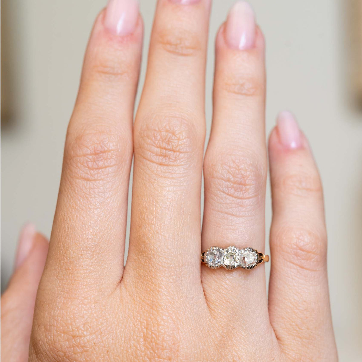 Victorian diamond engagement ring shown at full scale on the hand