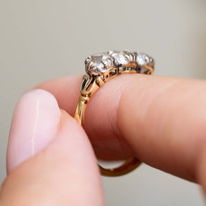 Side profile showing the ornate gallery of a Victorian three-stone diamond ring