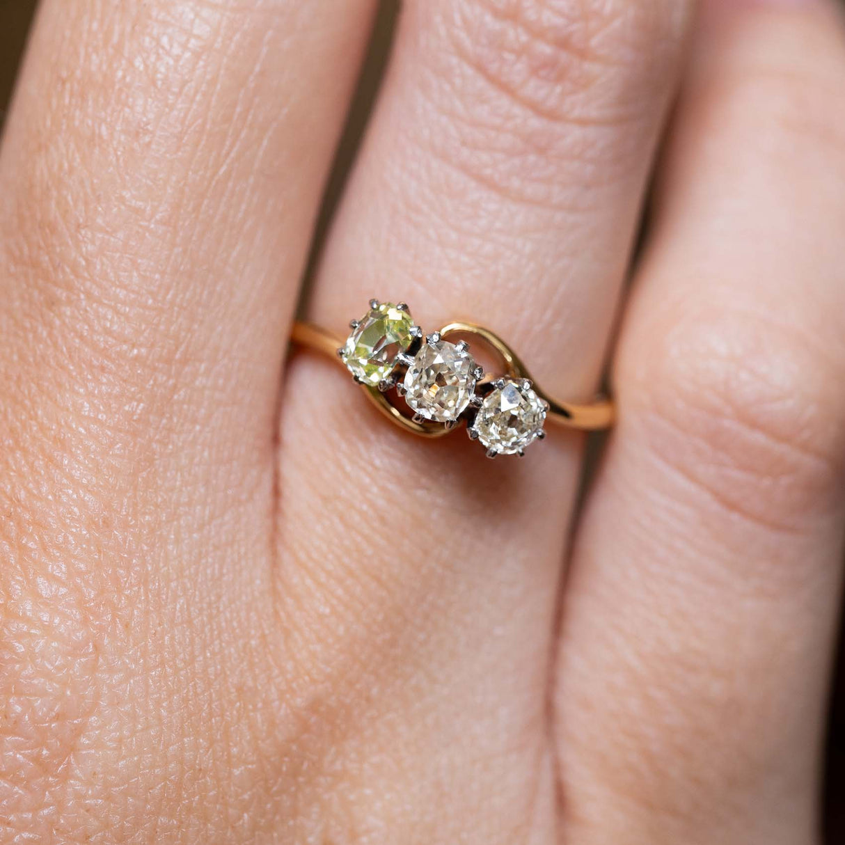A close-up of three antique diamonds in an Art Nouveau engagement ring