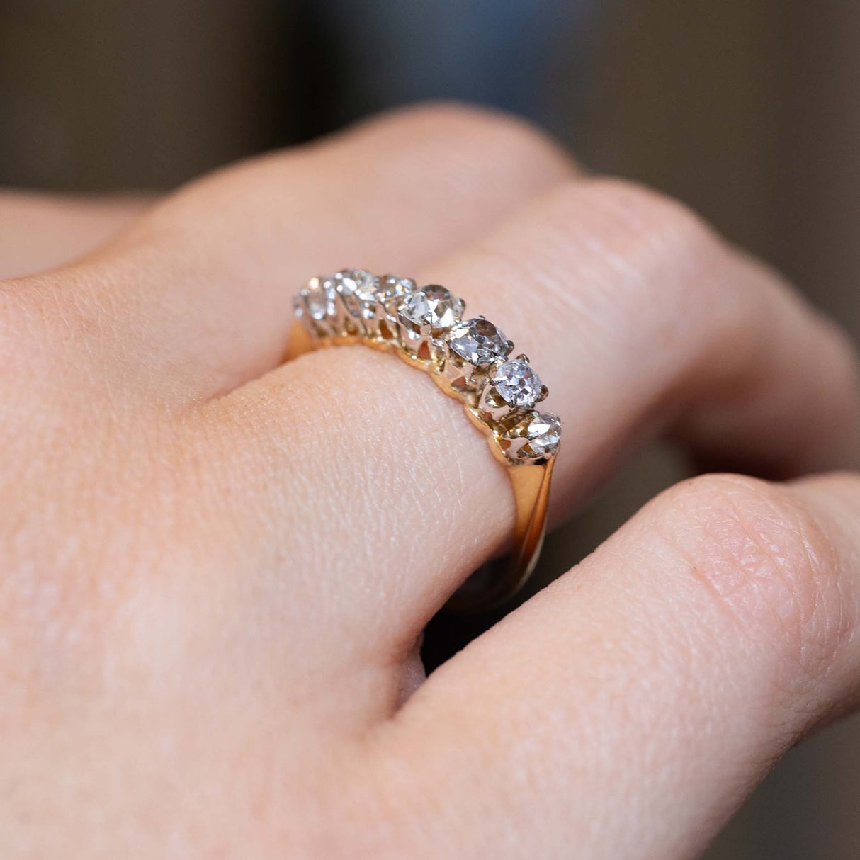 Angled view of the graduated diamond ring worn on the finger