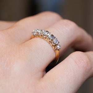 Angled view of the graduated diamond ring worn on the finger
