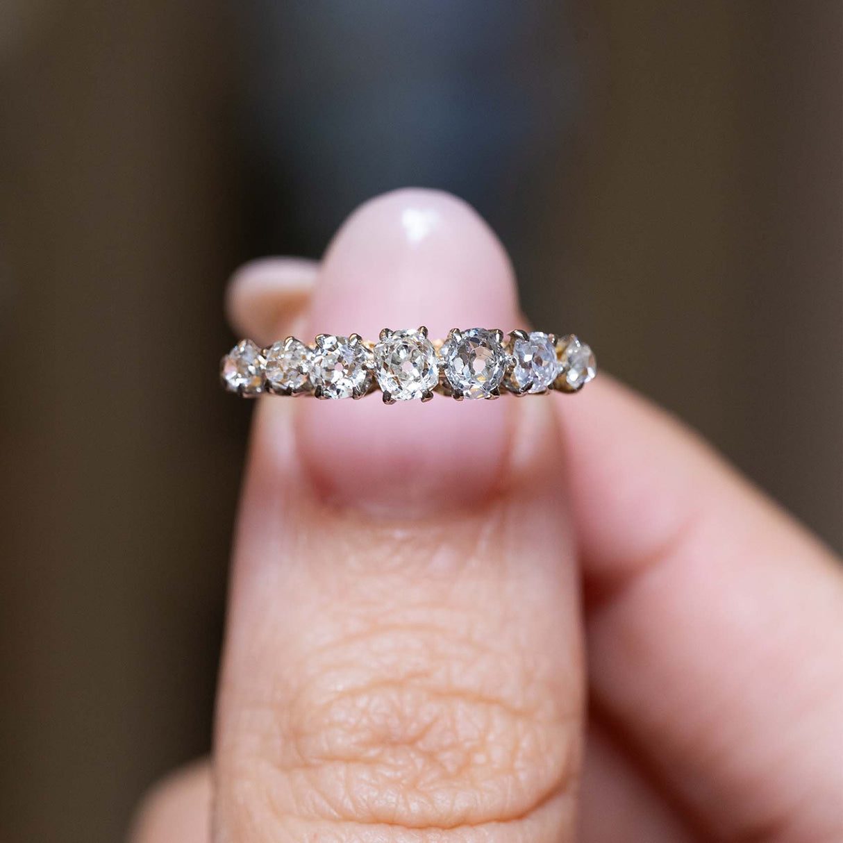 Close-up of seven graduated diamonds set across the finger